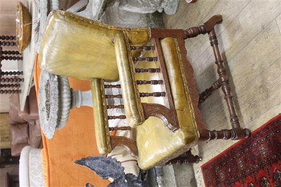 A pair of Victorian oak library chairs, upholstered in pale green leather, W.68cm D.76cm H.102cm